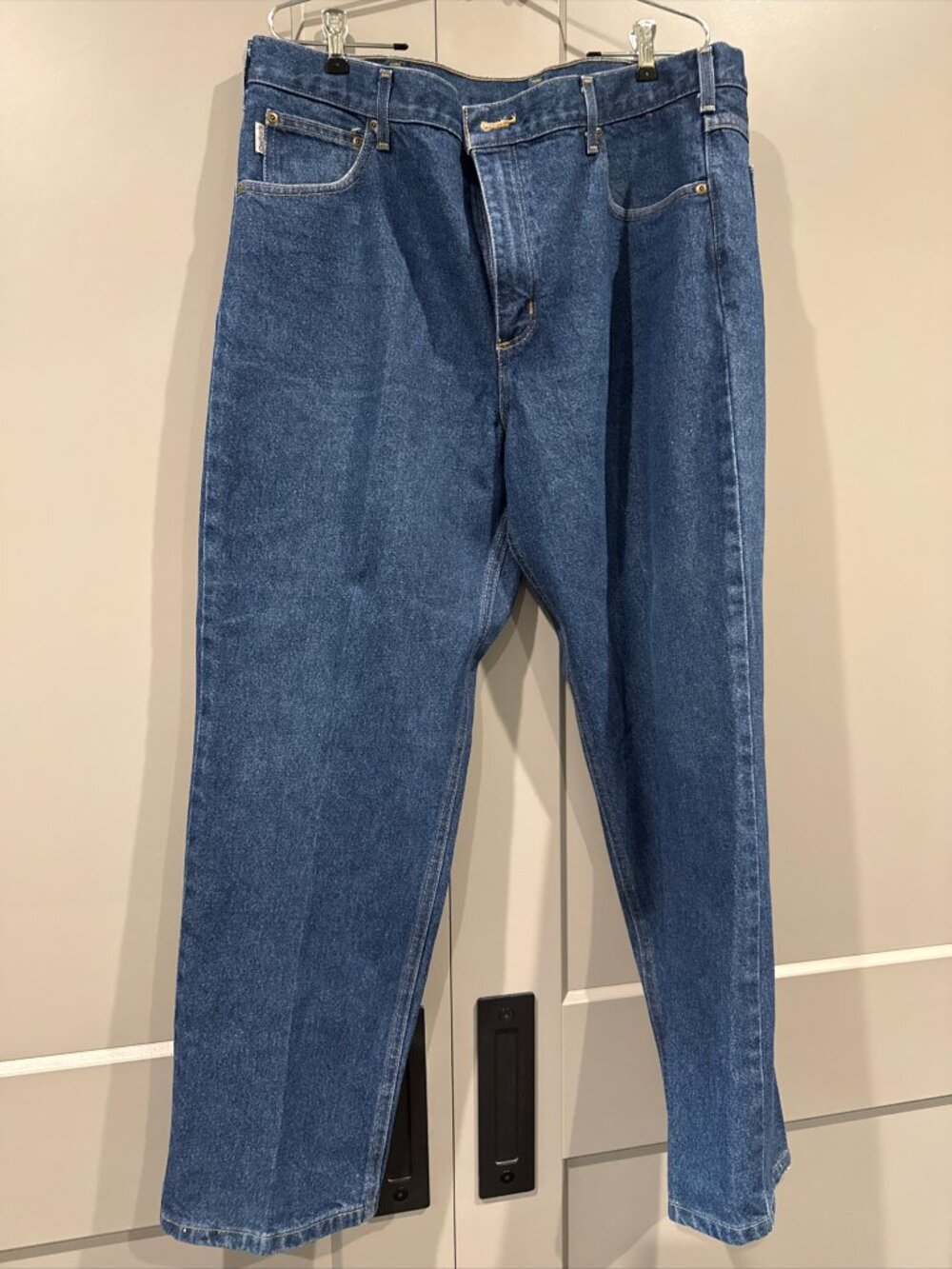 The Carhartt Straight Leg Jeans in a relaxed fit and dark wash denim are a versa